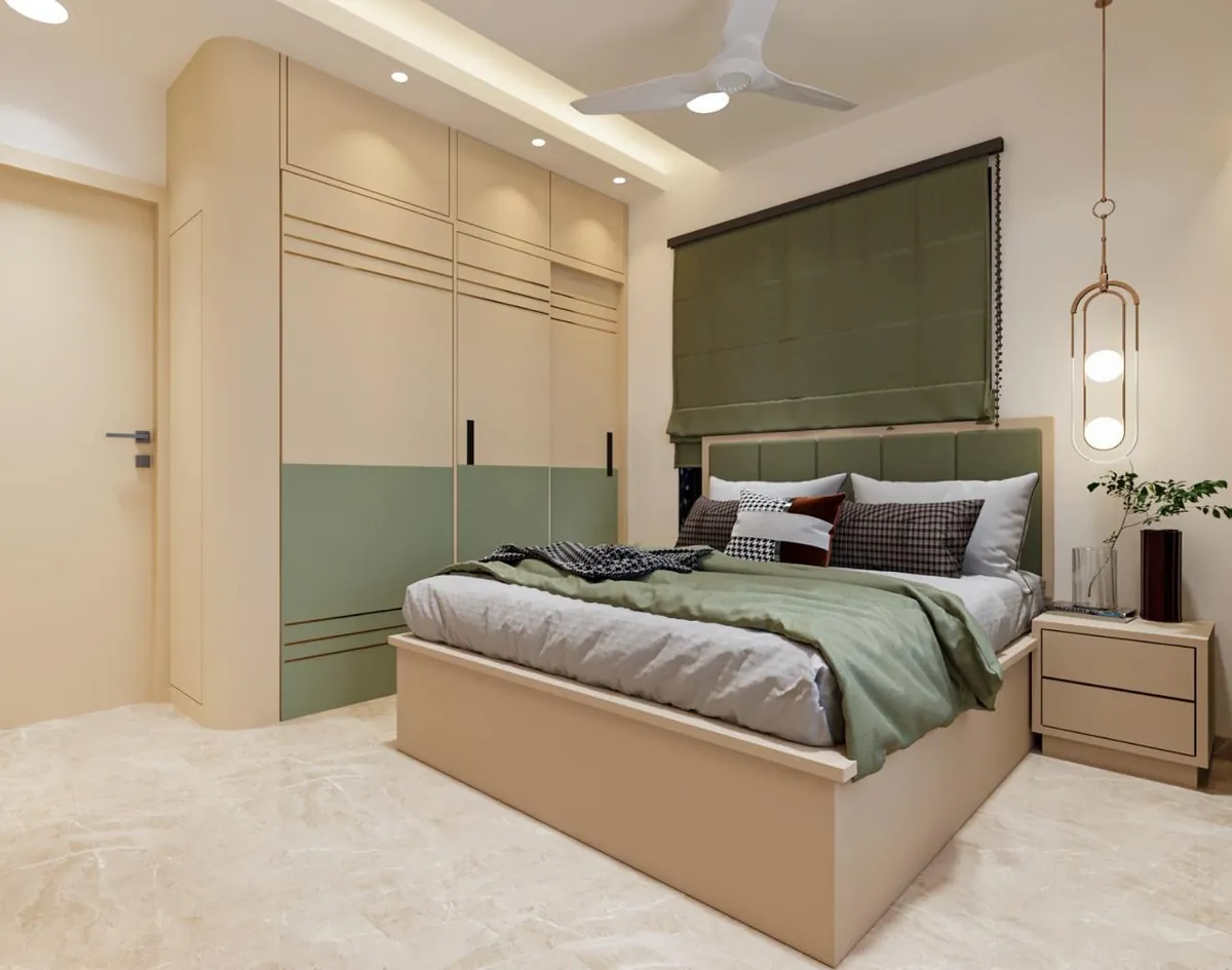 Curved two-tone sliding wardrobe in ivory and sage beside a green upholstered bed