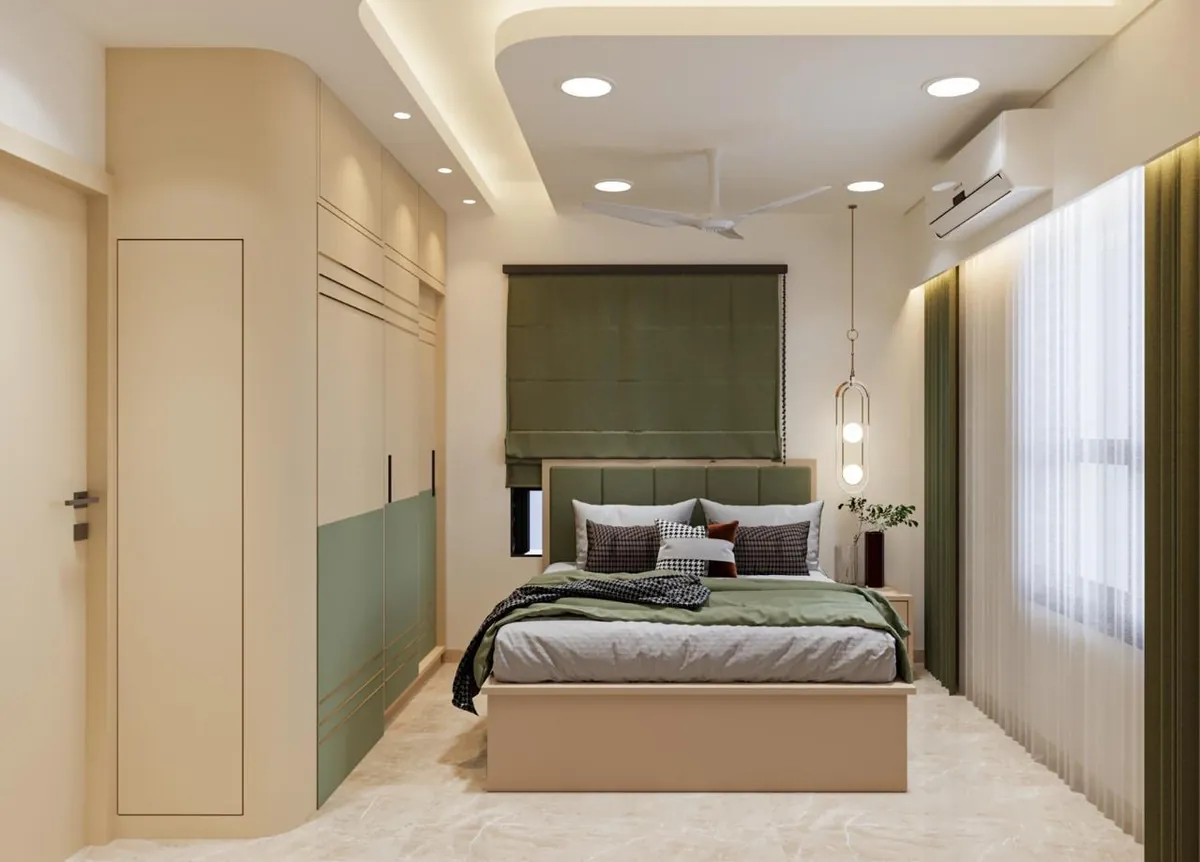 Bedroom with sage upholstered headboard, roman blind and curved ivory wardrobe
