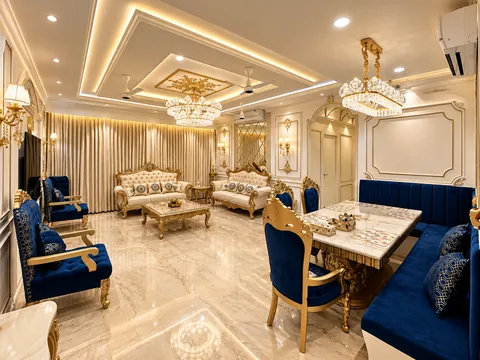Classical living and dining room in ivory and gold with navy velvet chairs and crystal chandeliers